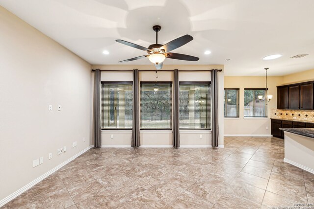 interior space featuring ceiling fan with notable chandelier