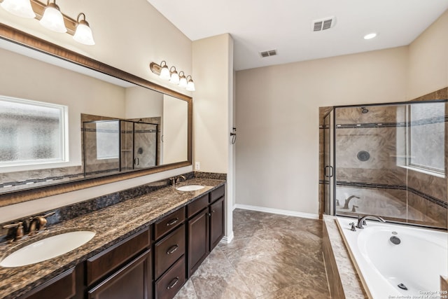 bathroom with vanity and shower with separate bathtub