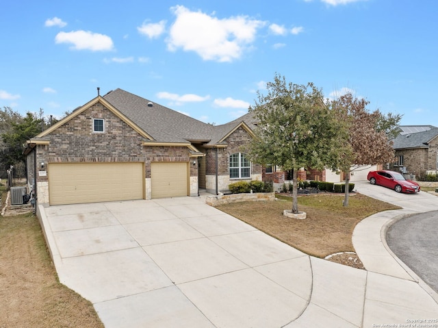 view of front of house with a front lawn, a garage, and cooling unit