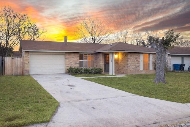 ranch-style house featuring a lawn and a garage