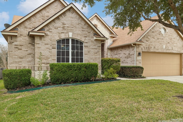 view of front of property with a garage and a front yard