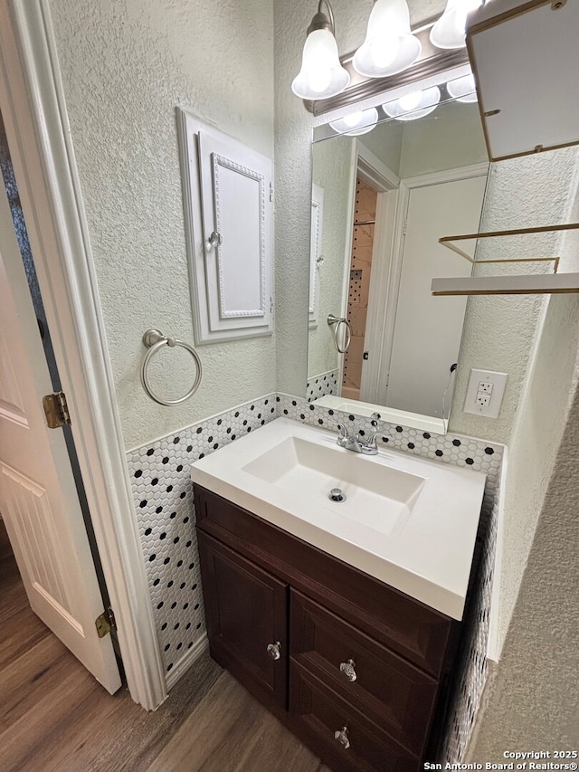 bathroom featuring hardwood / wood-style flooring and vanity