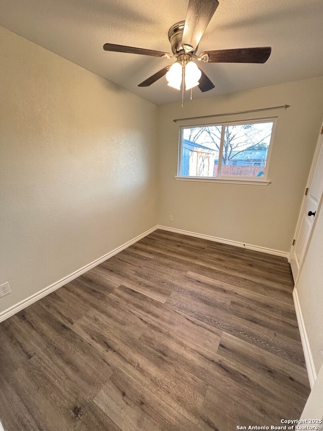 unfurnished room featuring ceiling fan and dark hardwood / wood-style floors