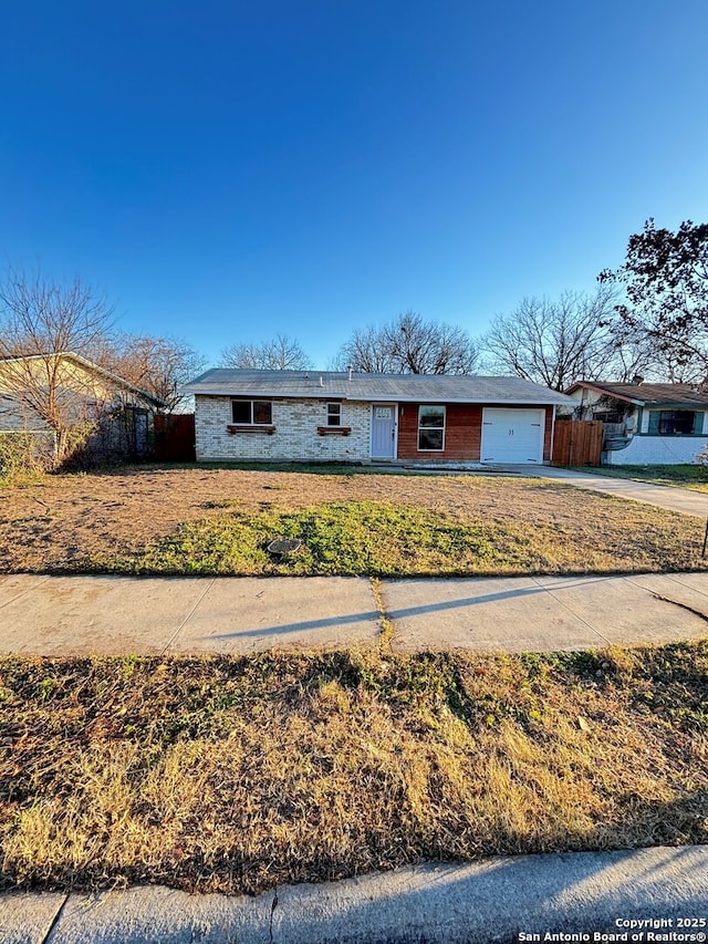 single story home with a front lawn and a garage