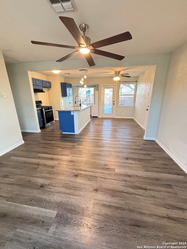 unfurnished living room featuring dark hardwood / wood-style floors and sink