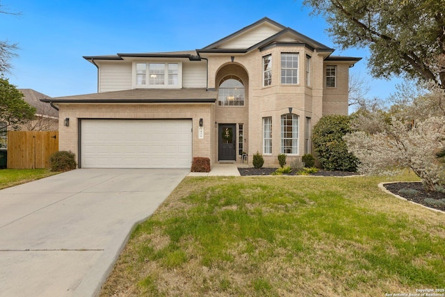 traditional home featuring an attached garage, brick siding, fence, concrete driveway, and a front lawn