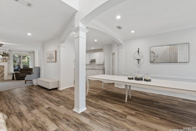 bathroom with decorative columns, visible vents, wood finished floors, and recessed lighting