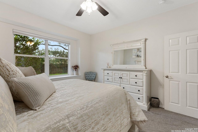 bedroom with a ceiling fan and carpet flooring