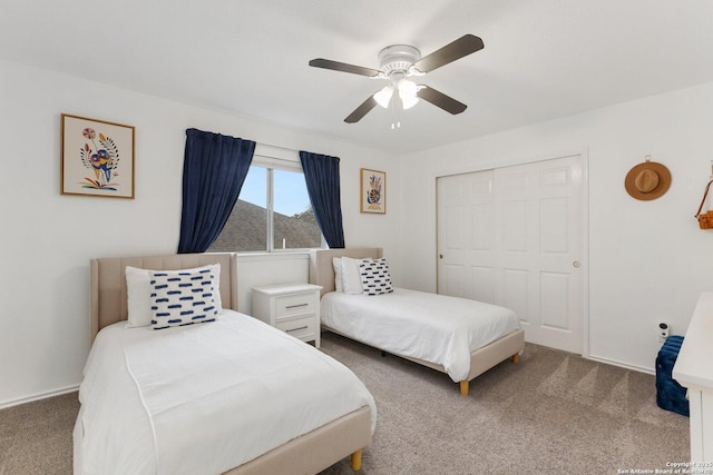 carpeted bedroom with a closet and ceiling fan