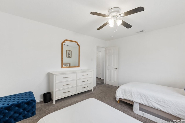 bedroom featuring carpet floors, visible vents, and a ceiling fan