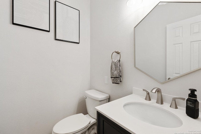 half bathroom featuring toilet and vanity