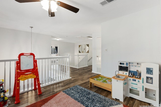 playroom featuring attic access, visible vents, and wood finished floors