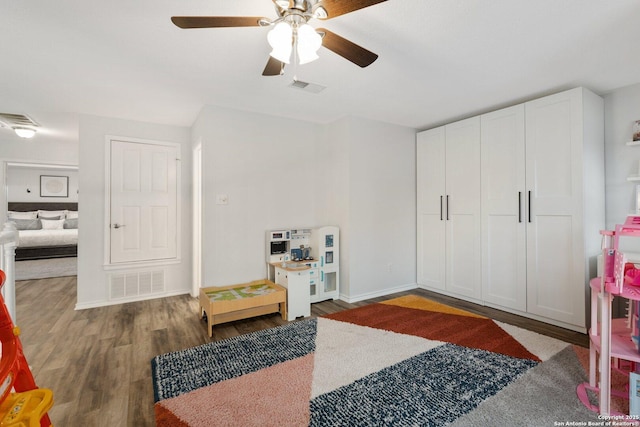 interior space featuring baseboards, visible vents, and wood finished floors