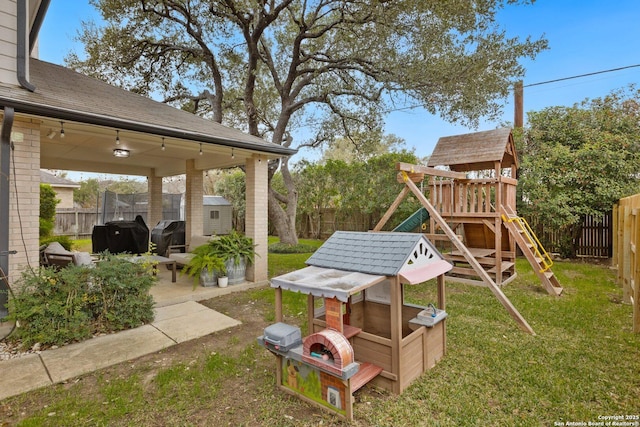 view of yard featuring a playground, a patio area, a shed, a fenced backyard, and an outdoor structure