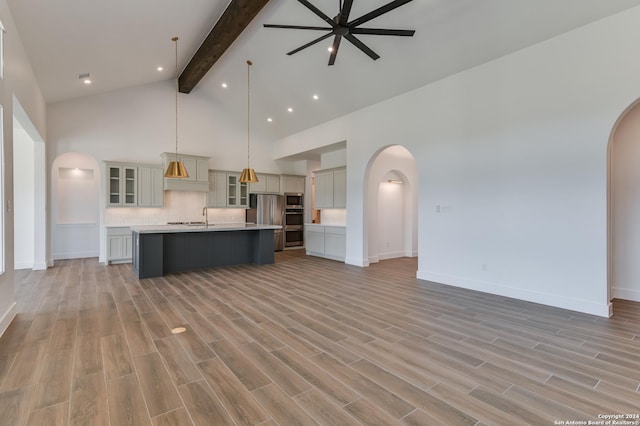 unfurnished living room featuring high vaulted ceiling, beamed ceiling, and light hardwood / wood-style flooring