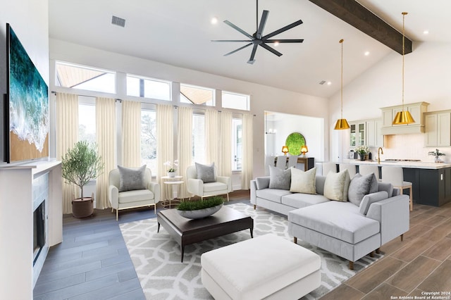 living room with ceiling fan, sink, and lofted ceiling with beams