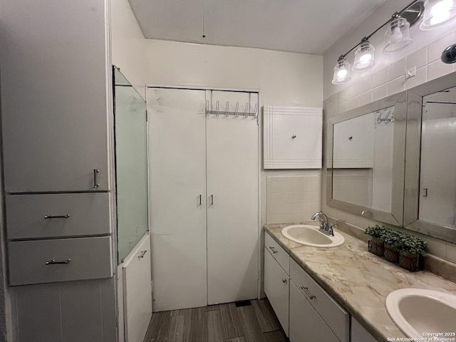 bathroom featuring vanity and decorative backsplash