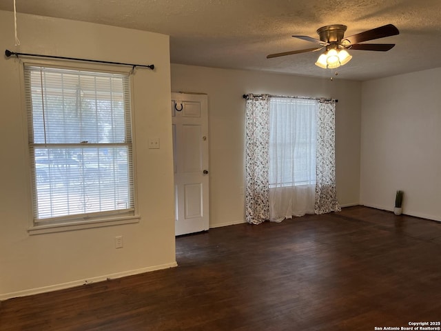 unfurnished room featuring a textured ceiling, ceiling fan, and dark hardwood / wood-style floors