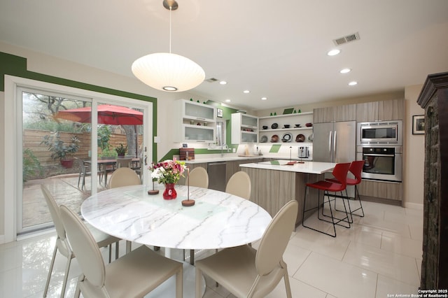 dining space featuring light tile patterned floors