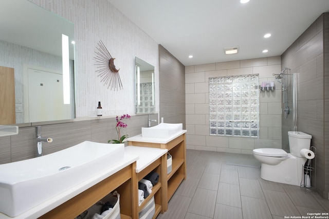 bathroom featuring toilet, a shower, and vanity