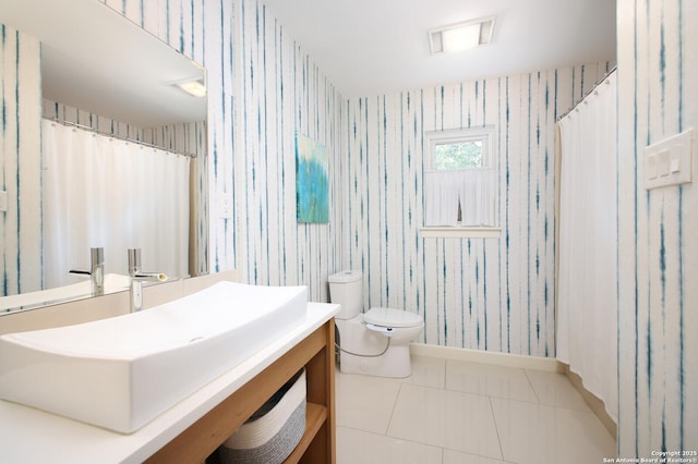 bathroom featuring toilet, vanity, and tile patterned flooring