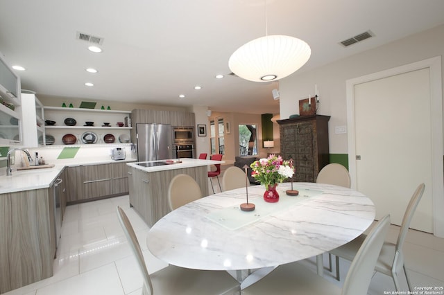 tiled dining room with sink