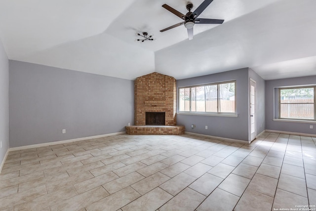 unfurnished living room featuring a fireplace, a healthy amount of sunlight, light tile patterned floors, and lofted ceiling