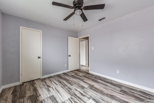 unfurnished room with ceiling fan and light hardwood / wood-style flooring