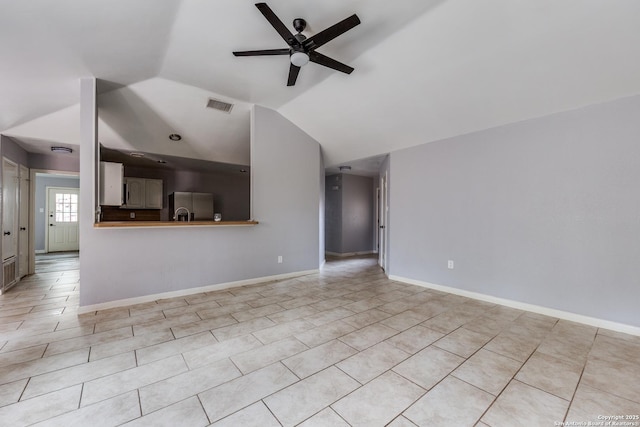 unfurnished living room with ceiling fan, light tile patterned flooring, and lofted ceiling