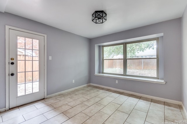 unfurnished room with light tile patterned floors