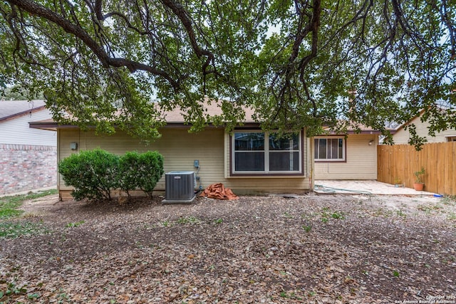 back of property with a patio area and central air condition unit