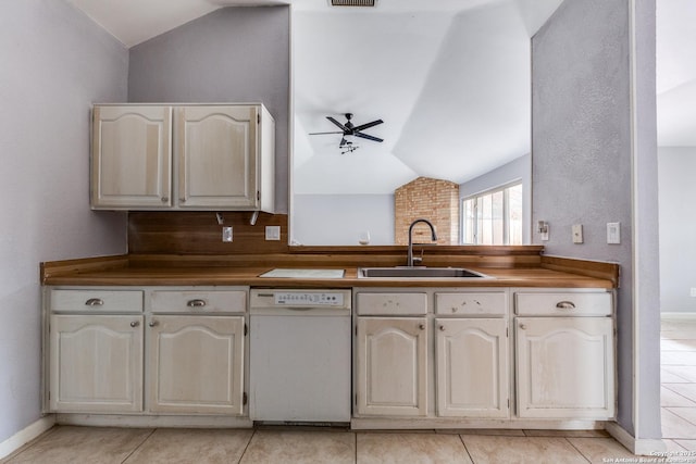 kitchen featuring vaulted ceiling, ceiling fan, sink, light tile patterned flooring, and white dishwasher