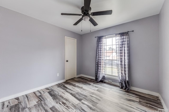 spare room featuring light hardwood / wood-style floors and ceiling fan