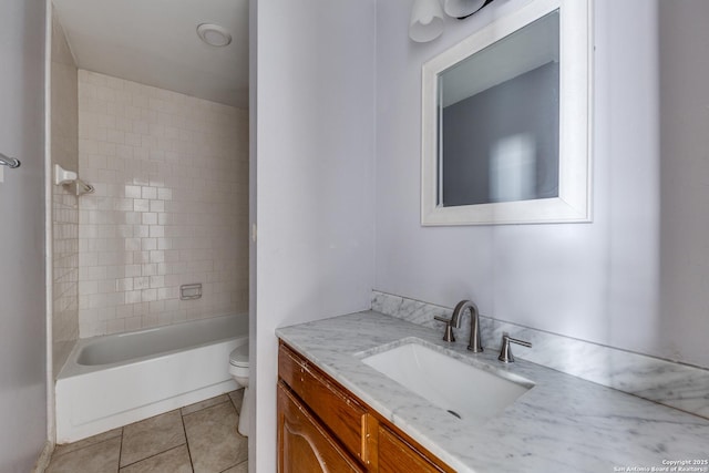 full bathroom featuring vanity, toilet, tile patterned floors, and tiled shower / bath