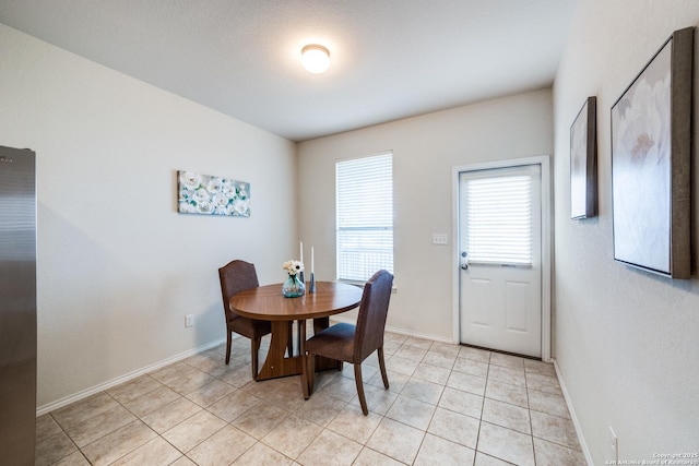 dining space featuring light tile patterned floors