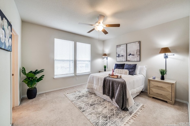 bedroom featuring ceiling fan and light colored carpet