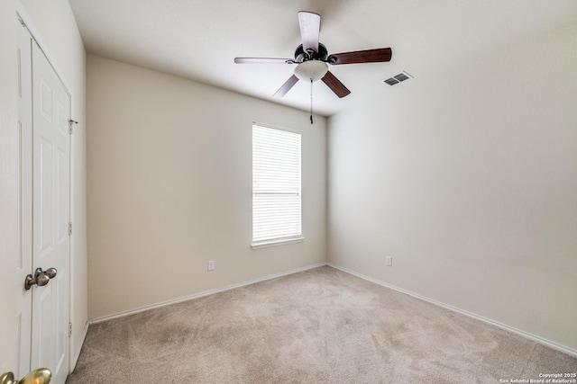 carpeted empty room with ceiling fan