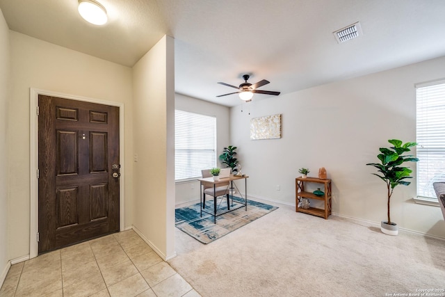 entrance foyer with light tile patterned floors and ceiling fan