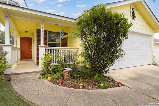 view of front of home with a garage and a porch