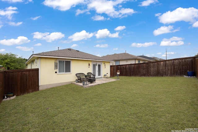 rear view of property with a patio and a yard