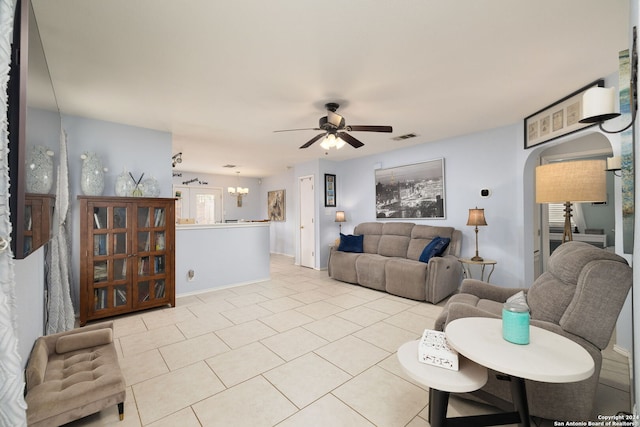 living room featuring ceiling fan with notable chandelier and light tile patterned flooring