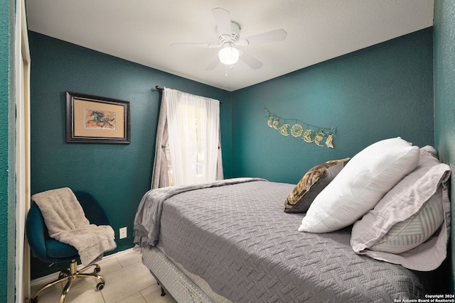 tiled bedroom featuring ceiling fan