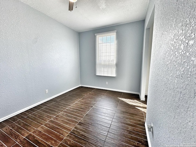 empty room featuring ceiling fan and a textured ceiling