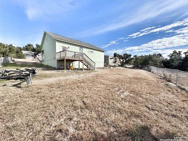 rear view of house featuring a wooden deck