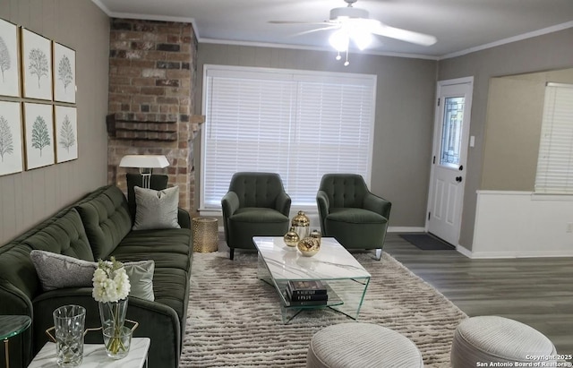 living room with ceiling fan, wood-type flooring, and crown molding