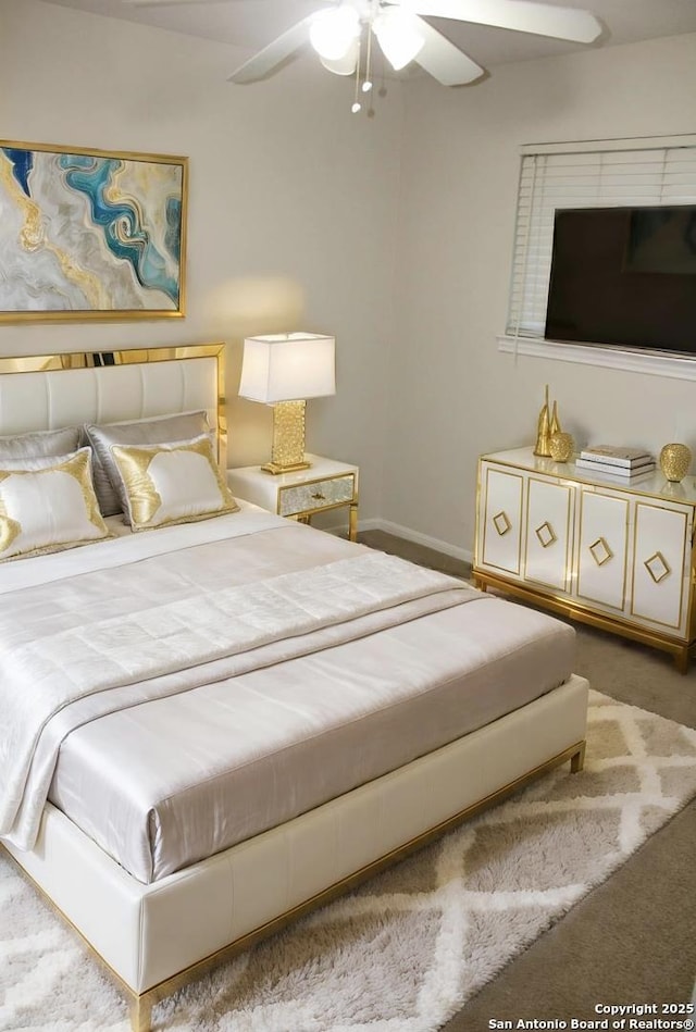 bedroom with ceiling fan and carpet floors