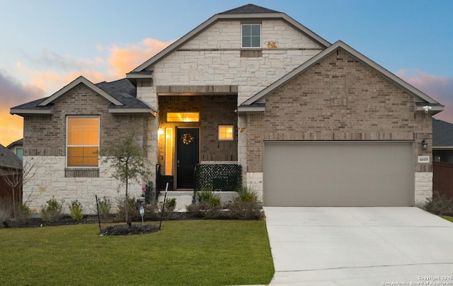 view of front of house featuring a garage and a yard