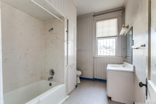 full bathroom with vanity, washtub / shower combination, crown molding, and toilet