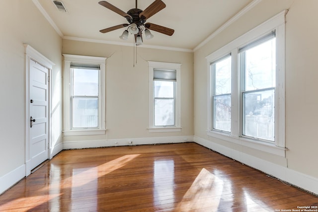 empty room featuring ceiling fan, crown molding, and light hardwood / wood-style floors