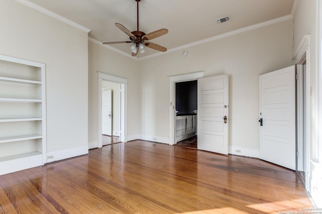 unfurnished bedroom featuring ceiling fan, ornamental molding, and hardwood / wood-style floors